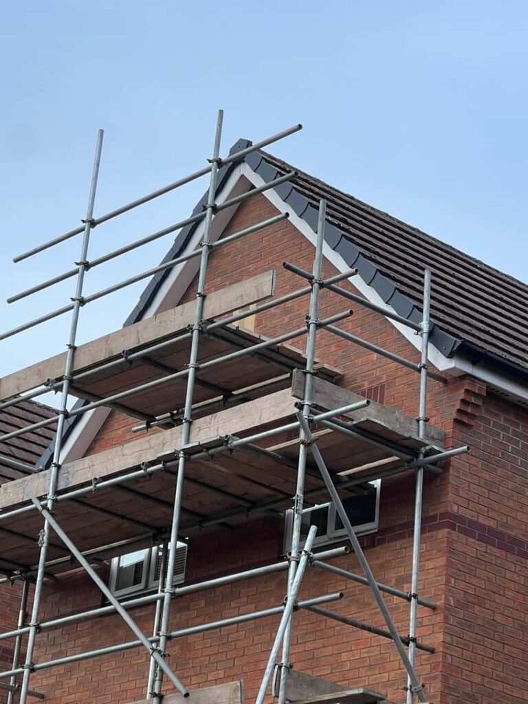 This is a photo of a roof which has just been repaired. There is a scaffold located at the gable end for access onto the roof. Works carried out by Coseley Roofing Repairs